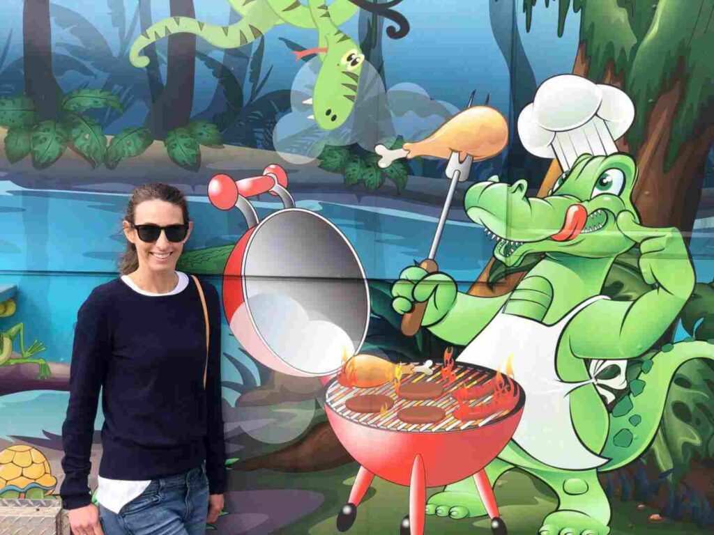 Woman in front of an alligator mural in Sawgrass Recreational Park