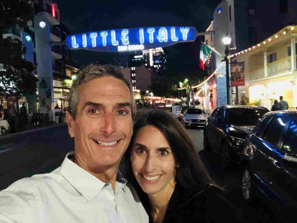 Couple in front of the Little Italy sign in downtown San DIego
