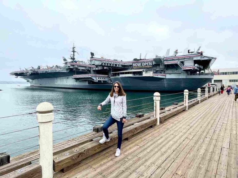 woman in front of uss midway in downtown san diego