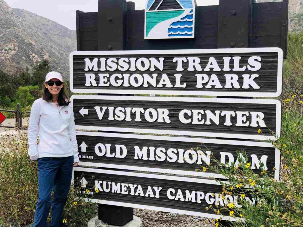 Mission Trails Regional Park in downtown San Diego with a woman in front of the sign