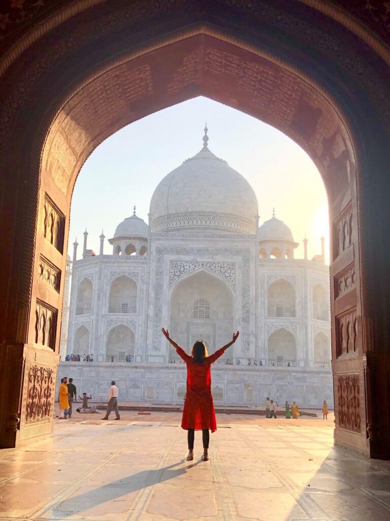 Woman in front of the taj mahal in an archway