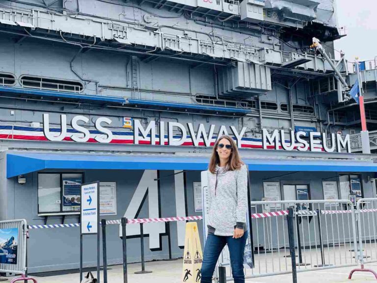 Woman in front of the USS Midway in Downtown San Diego