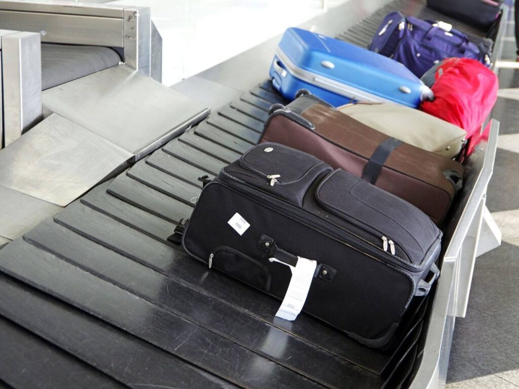 luggage on a conveyor belt, travel safety tips