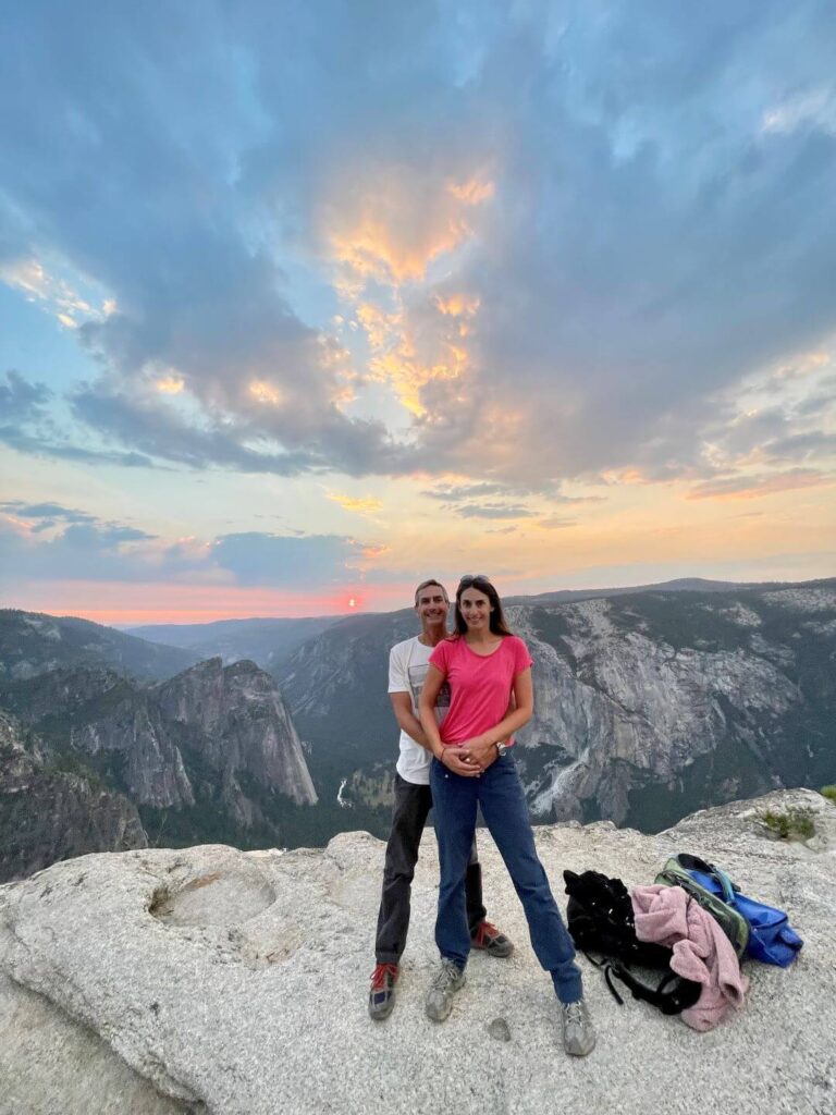 couple standing at Taft Point in Yosemite National Park at night
