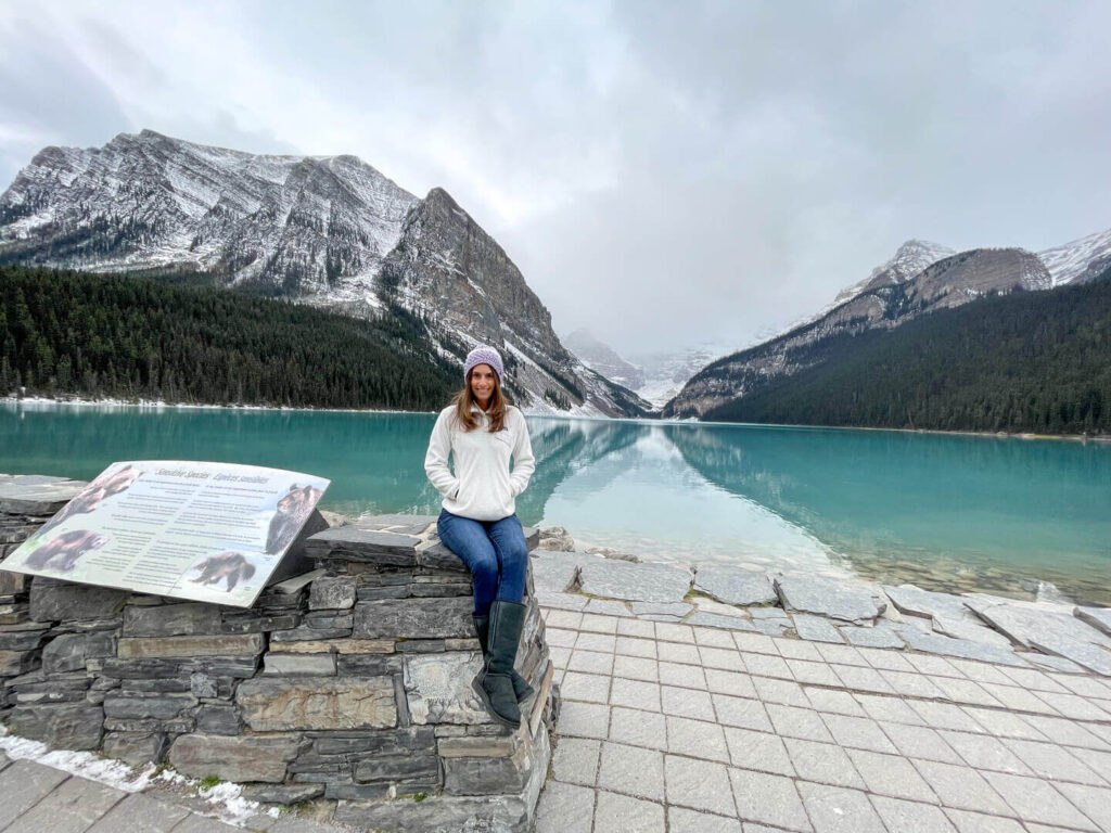 The best 4 day Lake Louise itinerary, woman sitting in front of Lake Louise