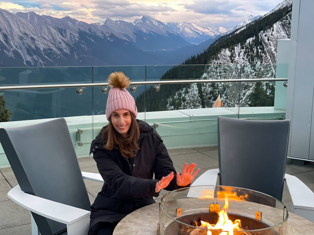 Woman warming her hands at Sulphur Mountain in Banff National Park