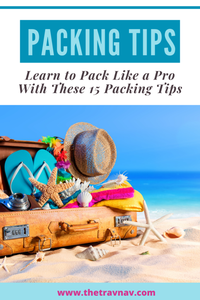 Suitcase on the beach filled with clothes to learn to pack like an expert