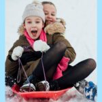 Children Sledding in the winter in Mammoth Lakes