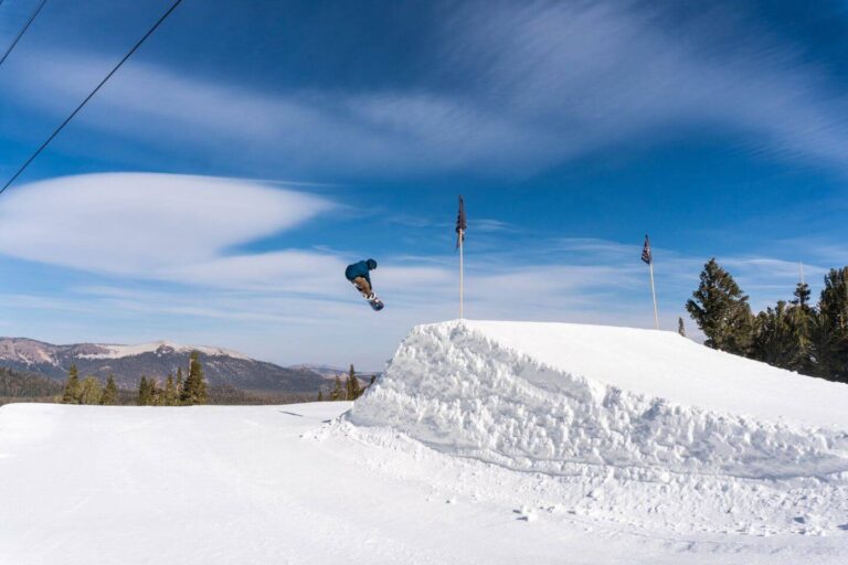 Snowboarding catching air at Unbound at Mammoth Mountain