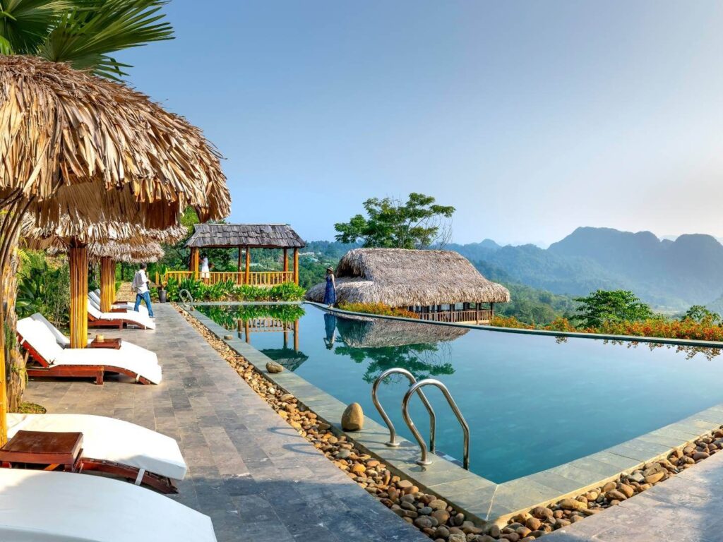 Tropical Hotel, Jungle hotel, mountain hotel, lounge chairs around a pool, sustainability program
