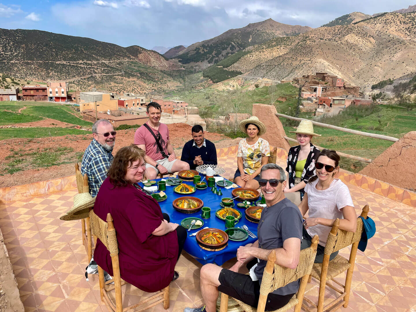Group rooftop dinner at a Berber home in the Atlas Mountains with views of the valley