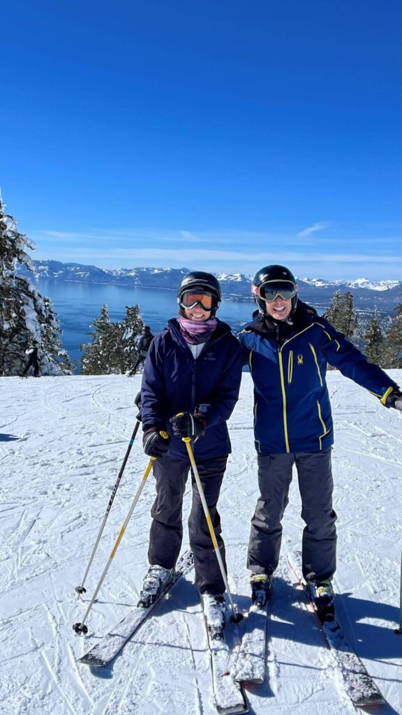 Couple skiing in Lake Tahoe with Lake Tahoe in the background