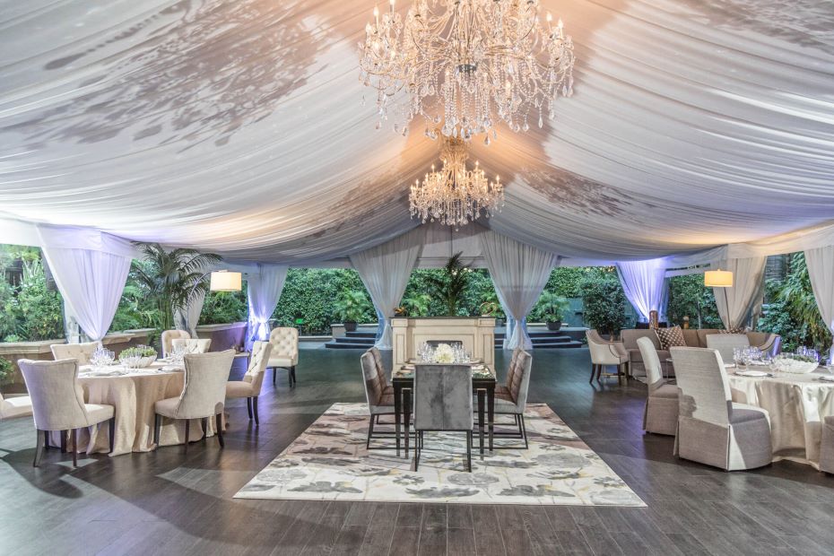 Outdoor event venue at Four Seasons Hotel Los Angeles at Beverly Hills under a white tent with a chandelier