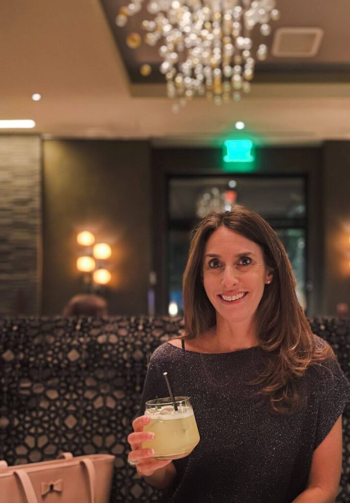 Culina - women holding a drink at The Four Seasons Hotel Los Angeles at Beverly Hills