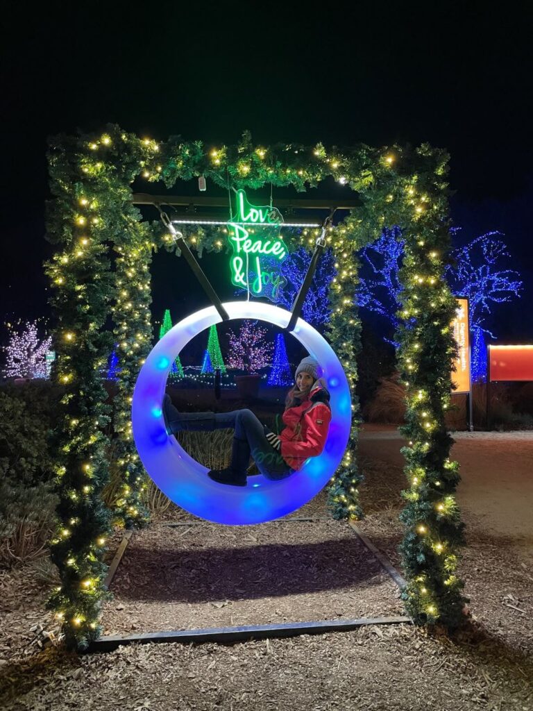 Women sitting in a glowing round swing