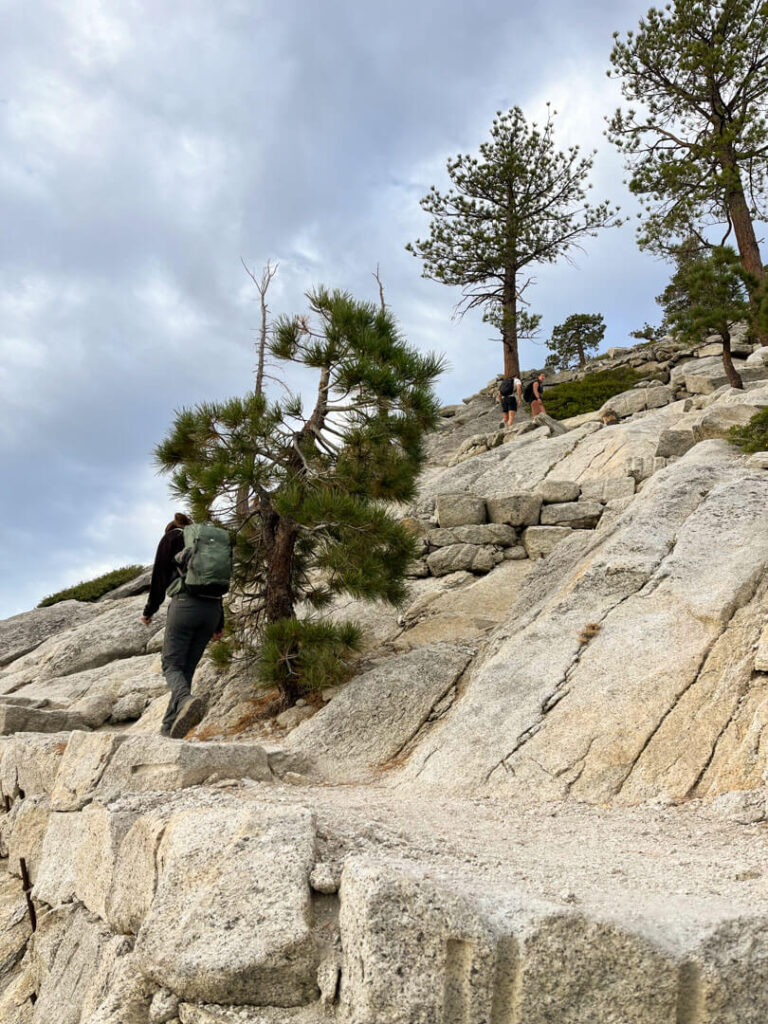 Woman climbing the subdome at Yosemite National Park