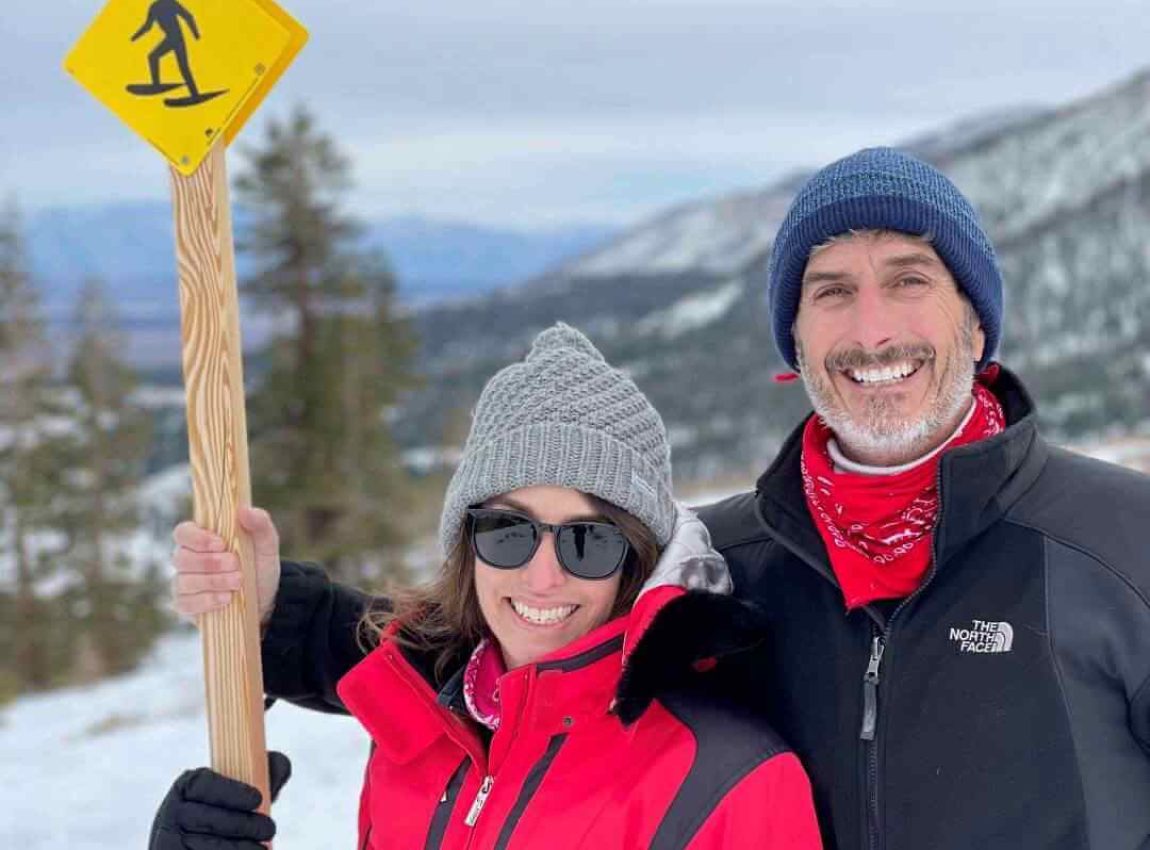 Couple at Panorama Dome by snowshoeing sign in Mammoth Lakes Winter