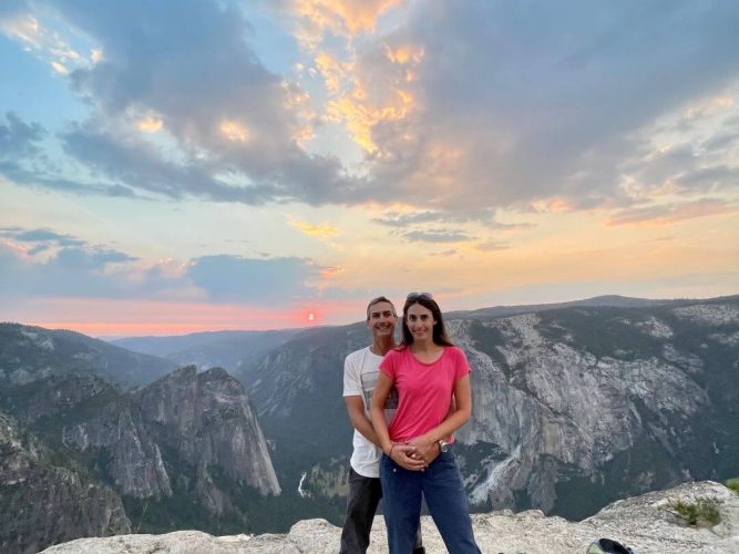 couple standing at Taft Point in Yosemite National Park at night