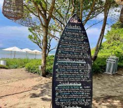 Lunch menu on a chalk surf board at El Surf Club Punta Mita