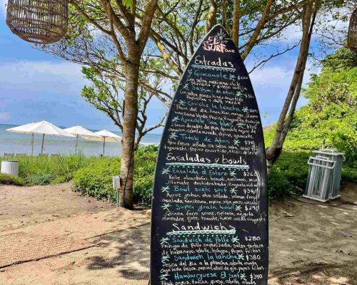 Lunch menu on a chalk surf board at El Surf Club Punta Mita